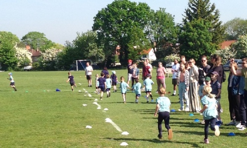 Children running the marathon with parents cheering them on 