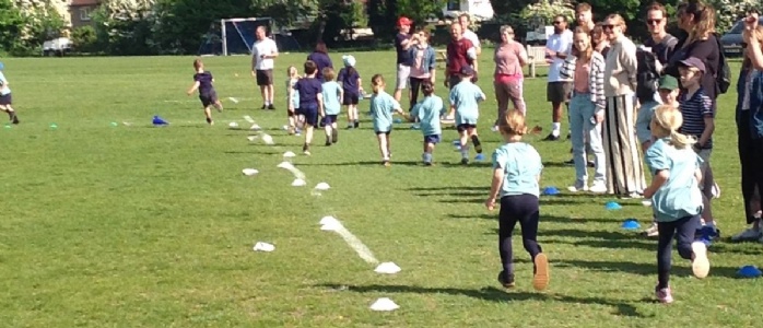Children running the marathon with parents cheering them on 